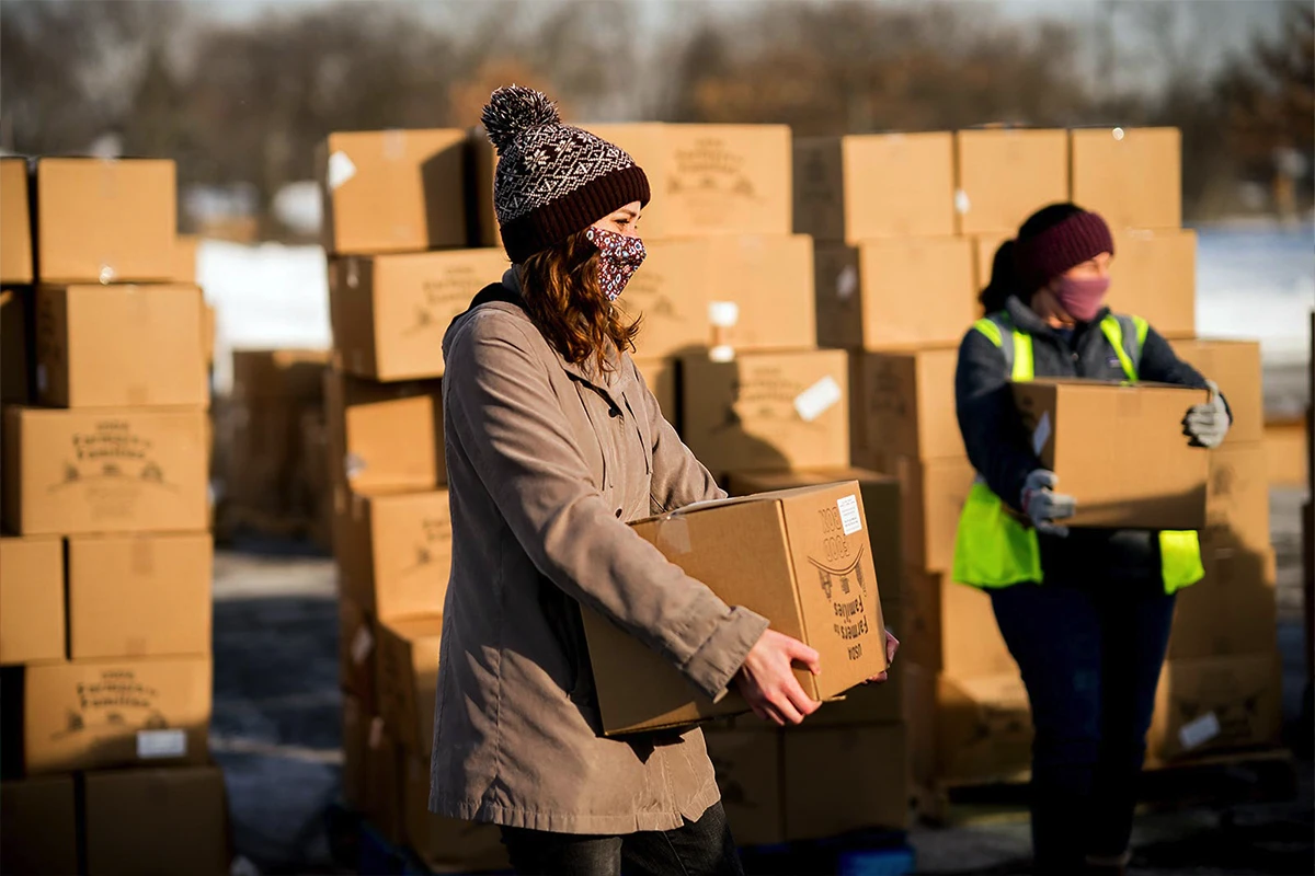 Women helping children at a registration table.