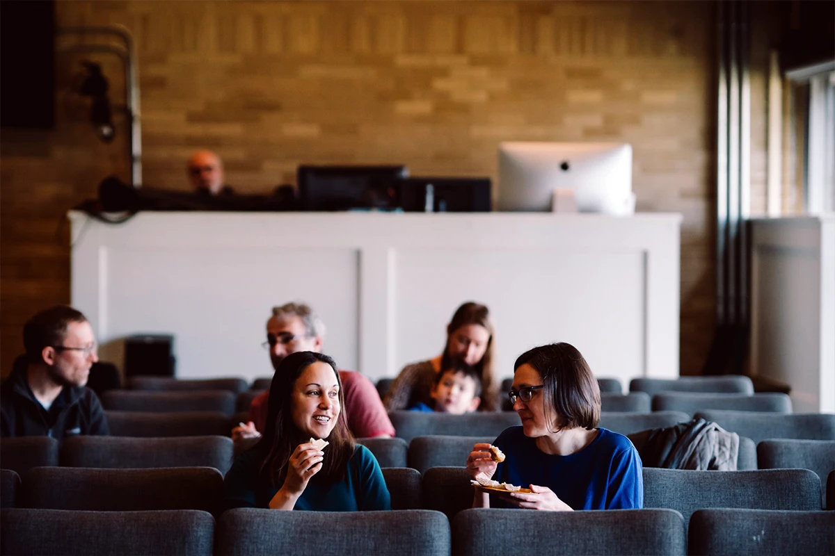 Young woman running a video camera.
